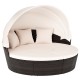 Round patio daybed with retractable canopy, white cushions, and hand-woven PE rattan for outdoor relaxation.