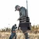 360° swivel portable hunting chair in black with adjustable legs and armrests, ideal for hunting and outdoor activities.