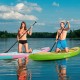 Two paddlers on inflatable stand-up paddle boards in vibrant colors, showcasing stability and versatility on the water.