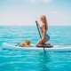 Inflatable stand up paddle board with a woman paddling and a dog, featuring a non-slip deck and triple fins for.