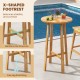 24-inch round teak wood bar table with X-shaped footrest, ideal for indoor and outdoor use by the pool or backyard.