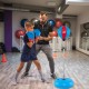 Adjustable punching bag with stand and boxing gloves in blue, ideal for kids and adults, enhancing coordination and.