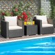 Two black wicker chairs with white cushions and a glass-top table, perfect for outdoor relaxation by the pool.