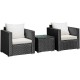 Two black wicker armchairs with white cushions and a glass-top coffee table, perfect for outdoor patio relaxation.