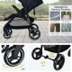 Lightweight black infant stroller with 5-point harness, adjustable backrest, and lockable front wheels for safety.