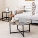 Round coffee table with gray tabletop and black metal frame, part of a 3-piece set for versatile living room use.