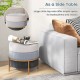 Round upholstered ottoman in gray with gold metal legs, serving as a side table for drinks and snacks.