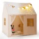 Kids play tent with glow in the dark stars, beige fabric, roll-up door, and colorful flags, perfect for imaginative.
