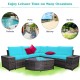 Cushioned 6-piece turquoise rattan sofa set with glass table, perfect for outdoor patio or poolside relaxation.