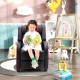 Kids recliner chair in red with side pockets and footrest, perfect for reading and relaxing in a playroom.