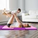 Folding gymnastics mat in pink and purple, featuring handles, ideal for fitness and yoga exercises at home.