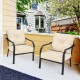 Two patio chairs with beige padded cushions and a sturdy black steel frame, perfect for outdoor relaxation.