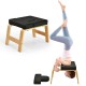 Yoga headstand bench with solid wood frame and soft black cushion, ideal for strength building and yoga practice.