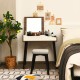Vanity table set with flip-top mirror and padded stool in brown, ideal for dressing and workspace organization.