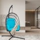 Turquoise hanging egg chair with soft cushion and sturdy stand, ideal for indoor or outdoor relaxation.