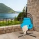 Hanging folding egg chair with turquoise cushion, durable hemp ropes, and sturdy steel frame for outdoor relaxation.