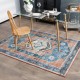 Distressed vintage 5 x 7 inch area rug with intricate pattern and colors, ideal for living room or dining room use.