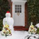 Set of 2 pre-lit snow-flocked Christmas trees with vivid ornaments, perfect for festive outdoor decoration.