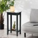 Black 2-tier end table with solid wood legs, ideal for bedside or sofa side, offering ample storage space.