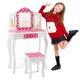 Kids vanity table and stool set in pink with polka dot print, showcasing a child posing playfully beside the stylish.