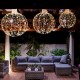 Three decorative Christmas LED light balls in golden hues, showcasing warm and white lights for festive outdoor.