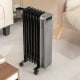 Portable 1500W oil-filled radiator heater in black with universal wheels, ideal for home and office warmth.