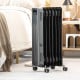 Portable oil-filled radiator heater in black, featuring 1500W power, 3 heat settings, and universal wheels for easy.