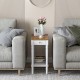 Narrow side table with drawer and open storage shelf, featuring a wooden top and white finish, ideal for small spaces.