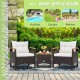 Patio rattan furniture set featuring two chairs and a table, with off-white cushions, ideal for outdoor use.