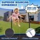 Child bouncing on a 12FT blue trampoline with safety net, featuring a 400 lbs weight capacity and premium jumping mat.