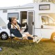 Hammock camping chair in navy with retractable footrest, mesh design, and cupholder, perfect for outdoor relaxation.