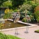 Set of 2 standing metal crane garden statues with detailed feathers, perfect for backyard or lakeside decoration.