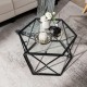 Hexagonal glass coffee table with a black geometric metal base, ideal for modern home decor and easy to clean.