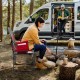 Folding camping director's chair in red with cooler bag and side table, perfect for outdoor use and easy transport.