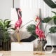 Two pink metal flamingo garden statues with U-shaped stakes, featuring delicate feathers for charming outdoor.