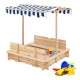 Kids wooden sandbox with blue striped canopy, showcasing convertible bench seats for added comfort during outdoor play.