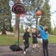 Portable basketball hoop stand with adjustable height, shatterproof backboard, and wheels for easy transport outdoors.