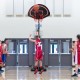 Portable basketball hoop with adjustable height, shatterproof backboard, and wheels for easy transport and stability.
