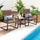 Two rocking chairs with brown PE rattan and lumbar pillows, paired with a table, perfect for outdoor patio relaxation.