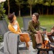 Adirondack rocking chair in gray with curved backrest, perfect for outdoor relaxation and balcony decor.