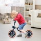 Kids riding the 4-in-1 trike bike in navy, featuring adjustable seat height and parent push handle for versatile use.