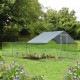 Large metal chicken coop with waterproof cover, featuring a sturdy design and ample space for various pets in a garden.