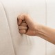 Close-up of the upholstered bed frame's geometric wingback headboard in breathable linen fabric for comfort and support.