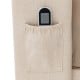 Close-up of the elastic pocket on the upholstered bed frame, ideal for storing remote controls and smartphones.
