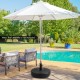 Heavy-duty 20-inch round umbrella base stand, fillable with sand or water, designed for stability in outdoor settings.