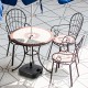Fillable black patio umbrella base with handle, designed for 1.5-inch poles, ideal for stability in outdoor settings.