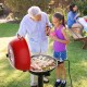 Portable electric BBQ grill in red with removable non-stick rack, perfect for outdoor cooking and gatherings.