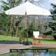 Sturdy outdoor umbrella base with wheels and handles, 20.5 inches, perfect for securing patio umbrellas in gardens.