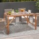 67-inch acacia wood dining table with umbrella hole, ideal for outdoor gatherings, shown with decorative items.