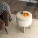 Round storage ottoman in beige with rubber wood legs, featuring a flip-over lid for snacks and ample internal storage.